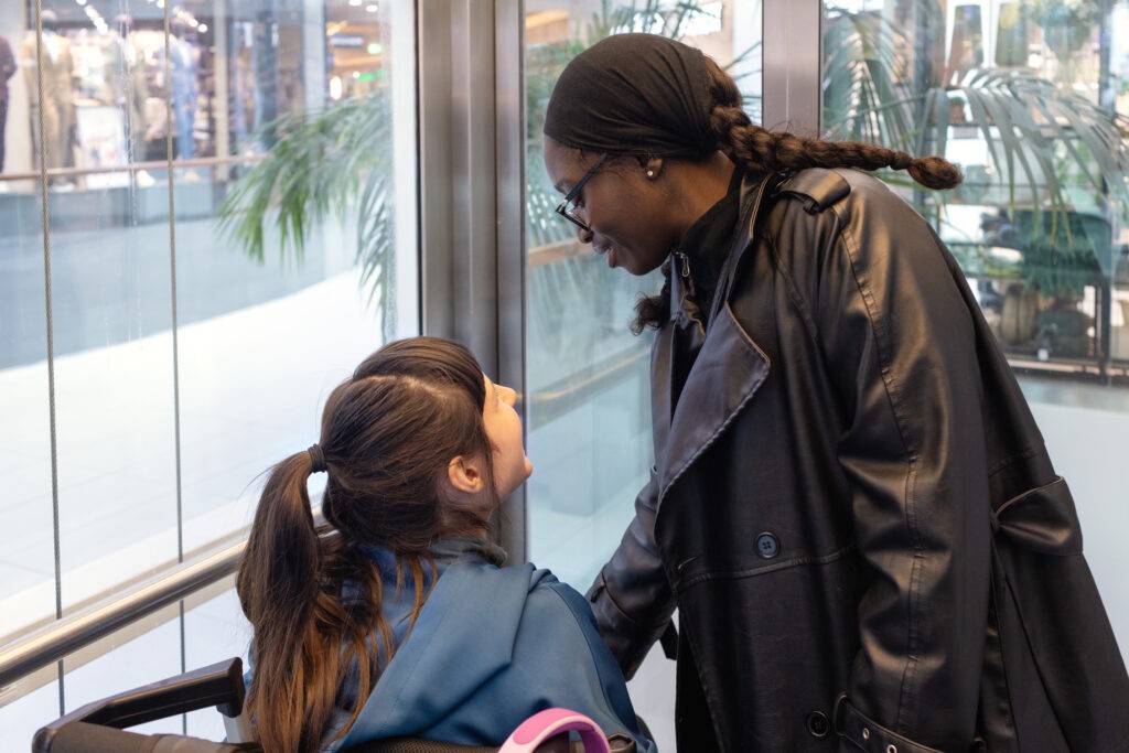Young woman in a wheelchair out shopping with her disability support worker